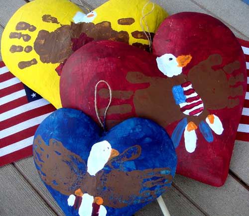 Handprint bald eagles on paper mache hearts by the boys